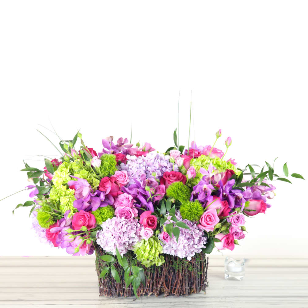 Full and colorful...this rectangular basket overflows with gorgeous pink tones of spray