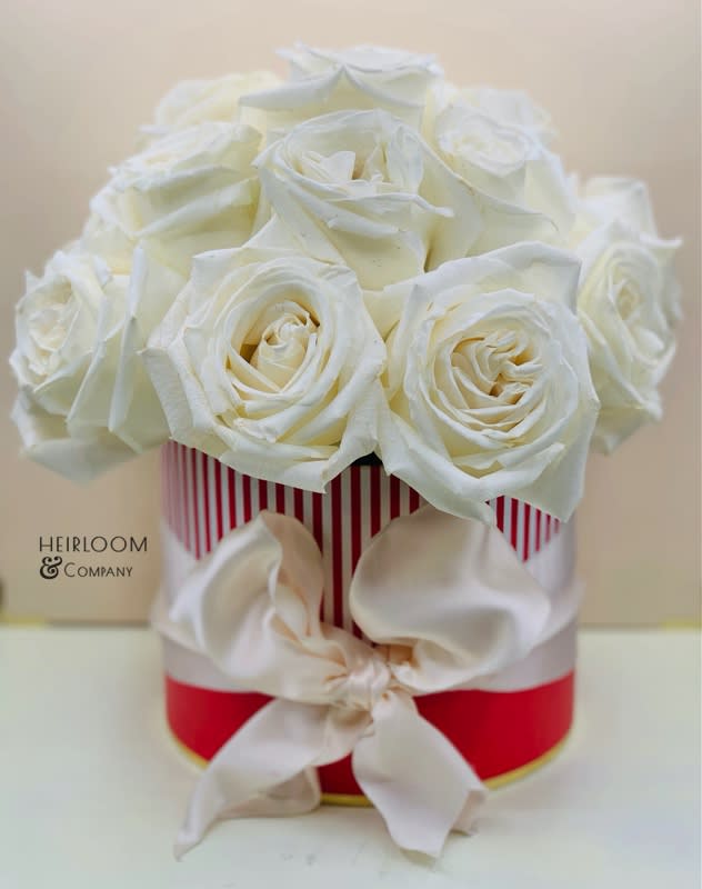 Ingredients:
Premium white roses
Red &amp; white striped hatbox
Tied in an ivory satin ribbon