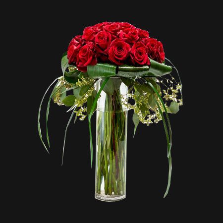 Our classic two dozen freedom red roses accented with seeded eucalyptus and