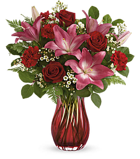 Elegantly swirling glass, radiant red roses and pretty pink lilies are sure