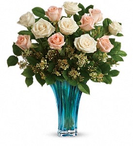 Spoil her with this breathtaking bouquet of 12 roses, hand-arranged in a