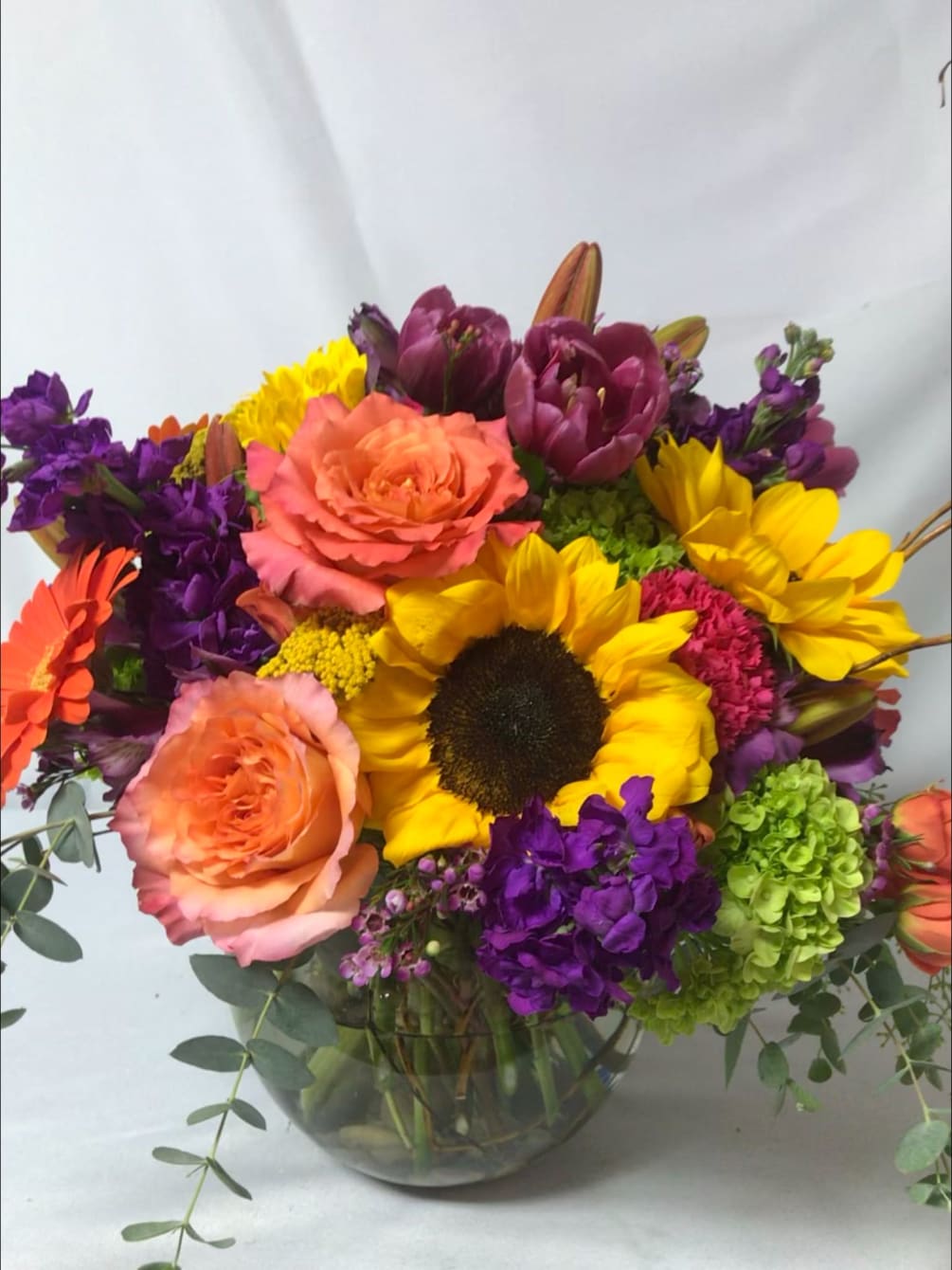 Yellow sunflowers and daisies, purple tulips and stock, pink and rose-colored blooms