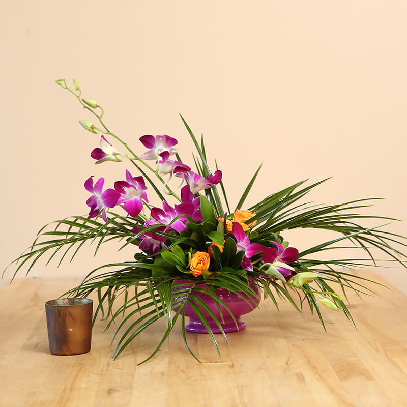 Eye-catching and dramatic, this arrangement is packed with Dendrobium orchids and exotic