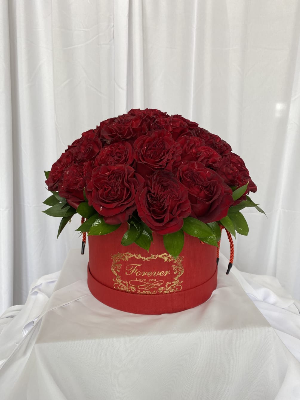 Traditional red roses arranged in a floral box. 

NOTE: photo shown is