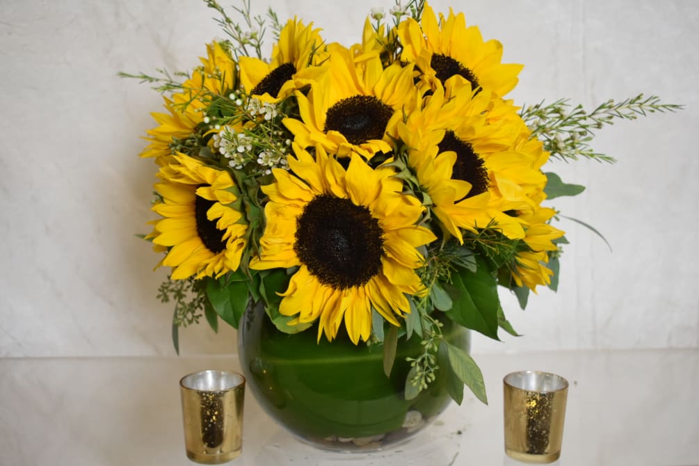 All sunflower arrangement in fishbowl vase 
It contains around 25 sunflowers with