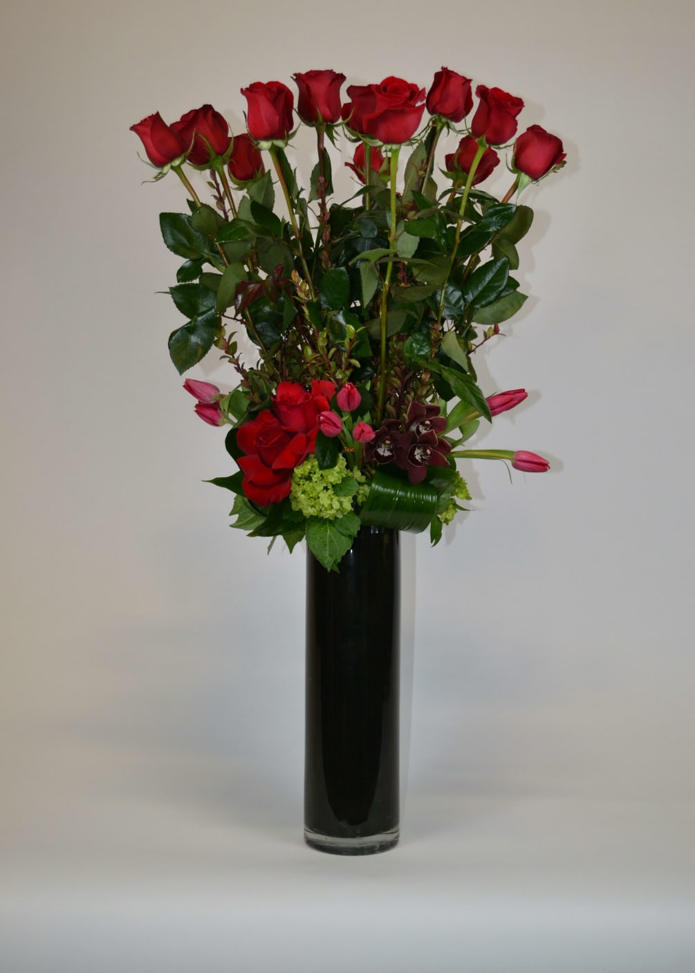 Long stem Red Roses and Red Tulips with a few Cymbidium Orchids