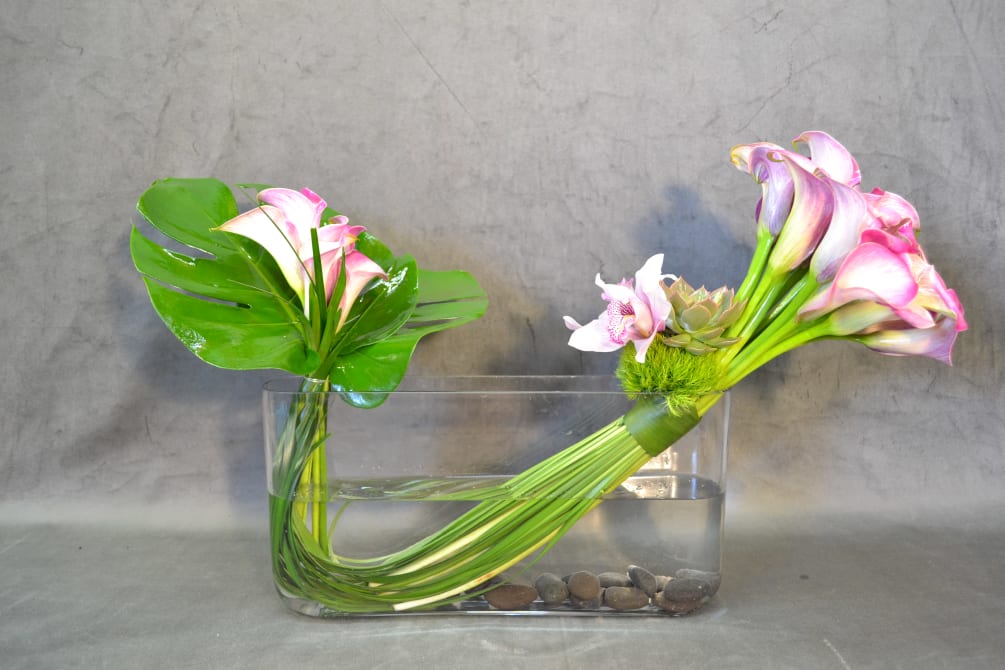 Calla lilies and a touch of cymbidium orchids and succulent.