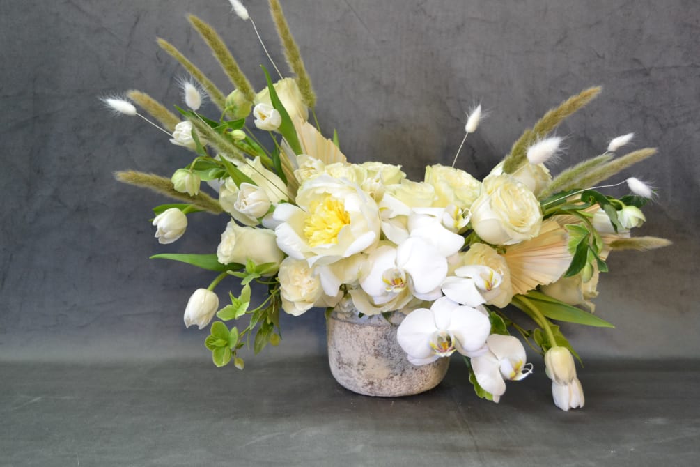 Beautiful vase with White Flowers. Roses, Peones, Phalaenopsis Orchids and Tulips.
