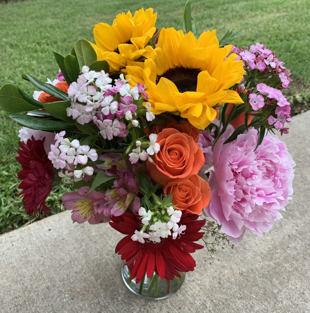A colorful arrangement to brighten anyone&rsquo;s day! The designer will select the