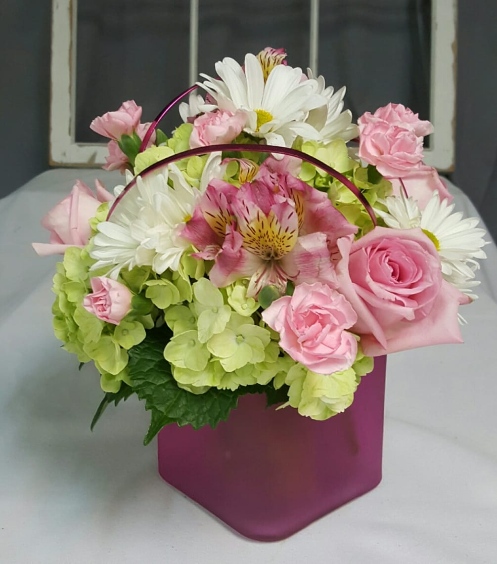This petite arrangement combines pink spray roses, alstromeria and mini carnations with