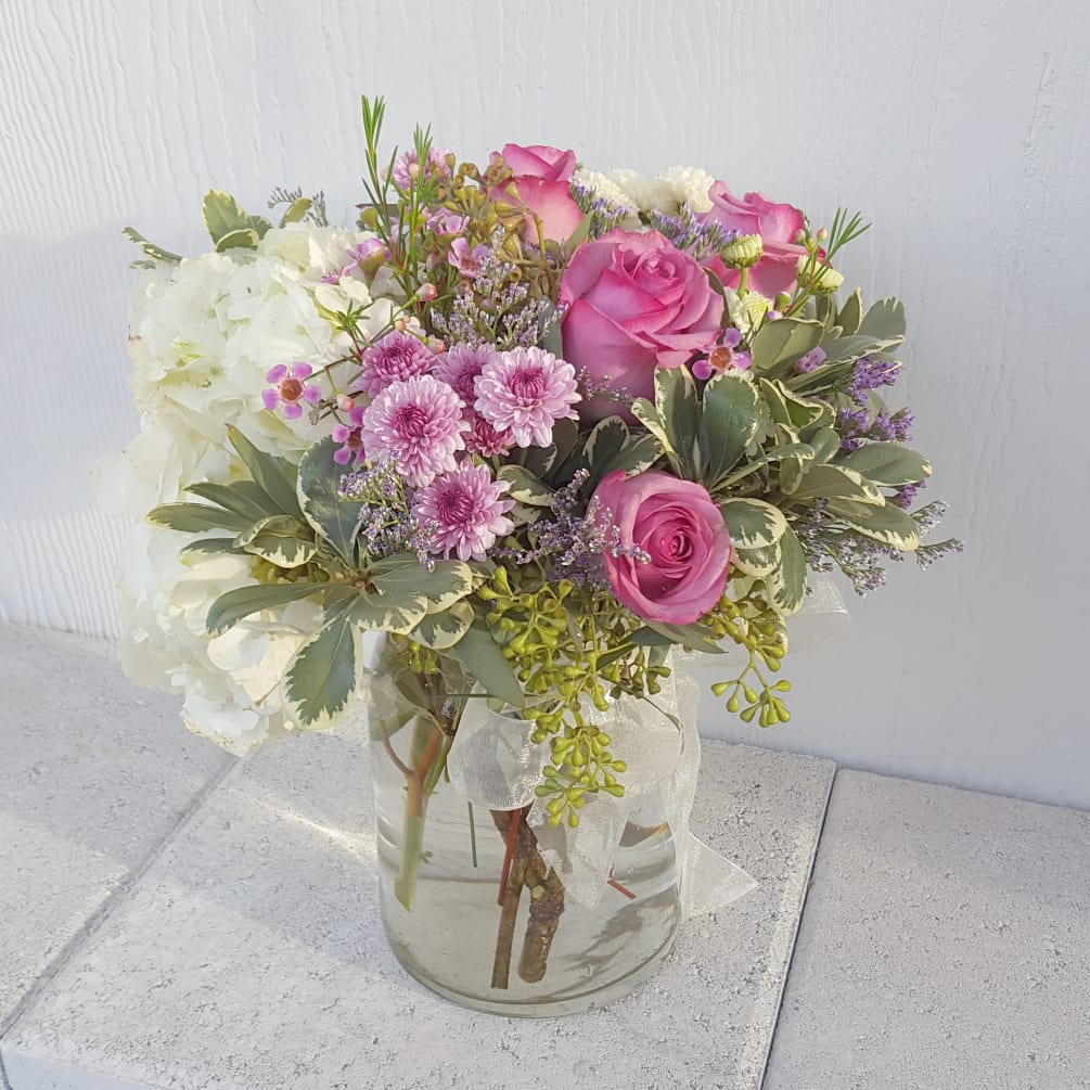Elegant arrangement of lavender roses and white hydrangea with a wisp of
