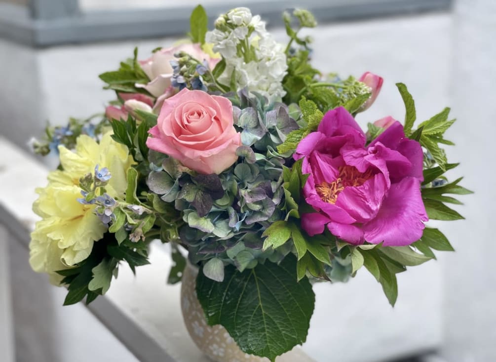 Grab a beautiful bouquet designed with hydrangeas, roses, peonies and fresh in