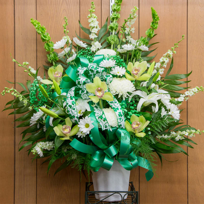 Beautiful green and white sympathy basket full of green and white flowers