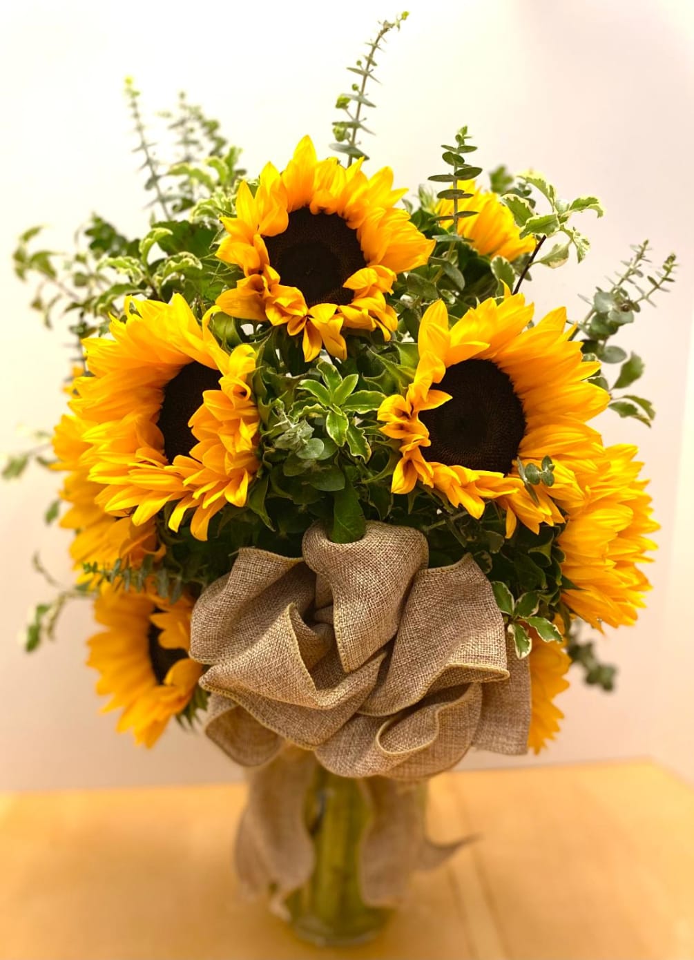 This warm and simple design includes a dozen Sunflowers nestled in Italian