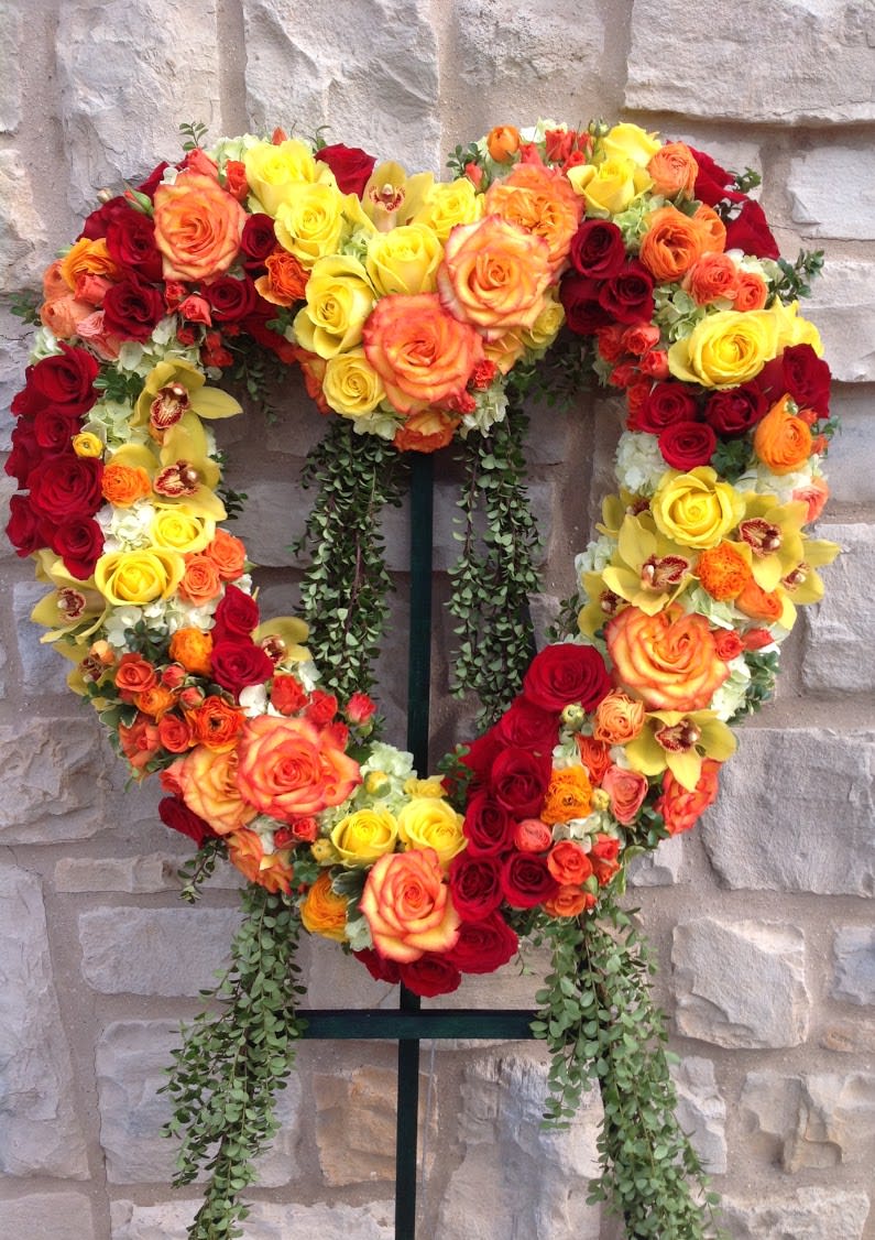 A 24 inch heart wreath with vibrant roses, orchids, and hydrangea.
