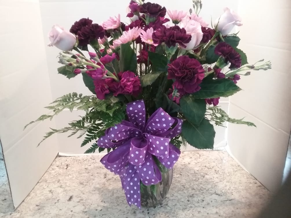 Various types of purple flowers make this the perfect arrangement for people