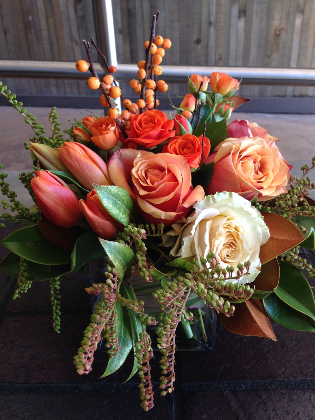 Mix of beautiful fall fillers including magnolia leaves, orange berries, tulips, spray