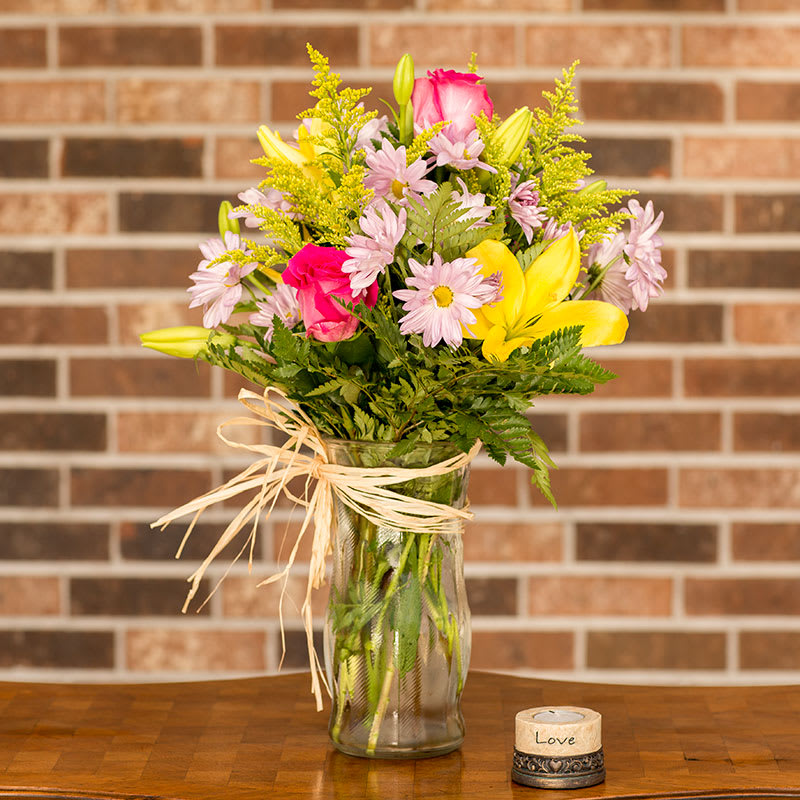 Vase of lilies, roses, daisies, and solidago