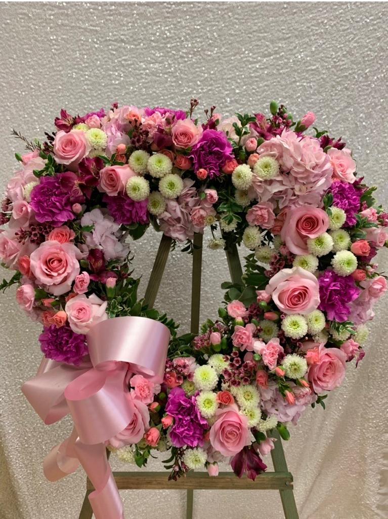 Celebrate life with pink and purple roses, carnations,spray roses, hydrangeas, mini carnations