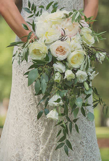 This beautiful cascading bouquet  mix of ivory roses, greenery and filler