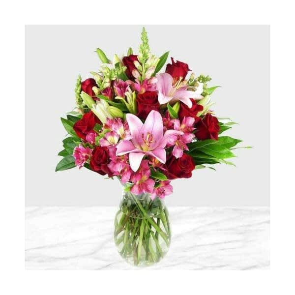 This arrangement has a beautiful light pink and red roses combination. Perfect