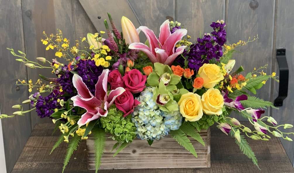 All the blooms spring offers in a beautiful boxed display. Arrangement includes