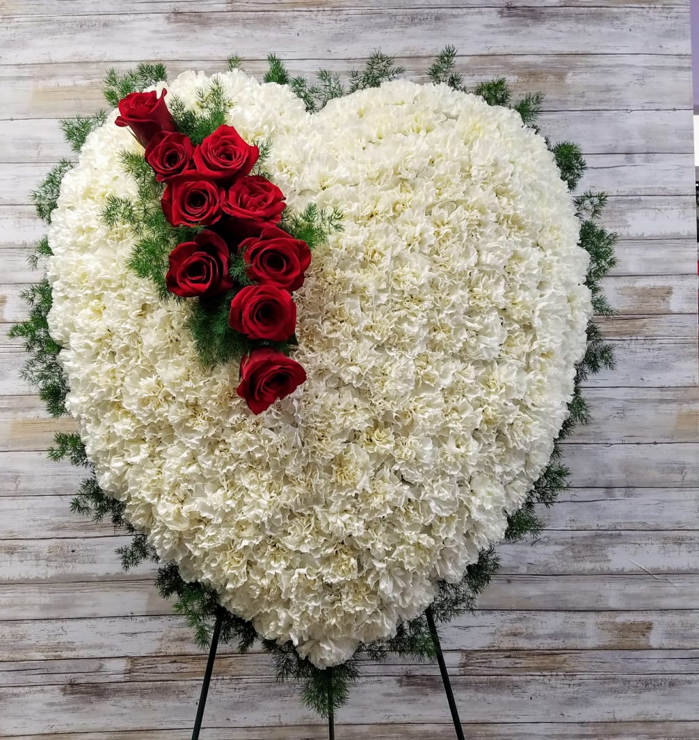 Over 175 White Carnations frame this large heart with a spray of