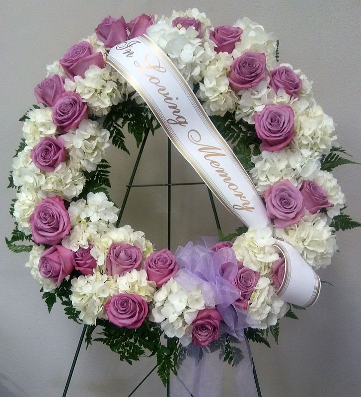 A heartfelt wreath made of lavender roses and white hydrangeas and a