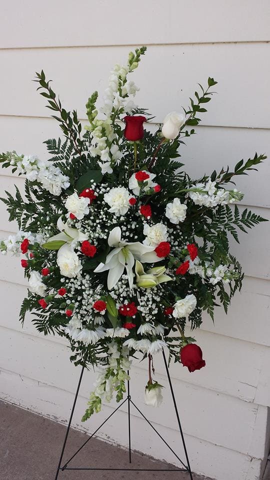 Easle Spray with White sanpdragons, carnations, lilies, roses , Red Carnations and