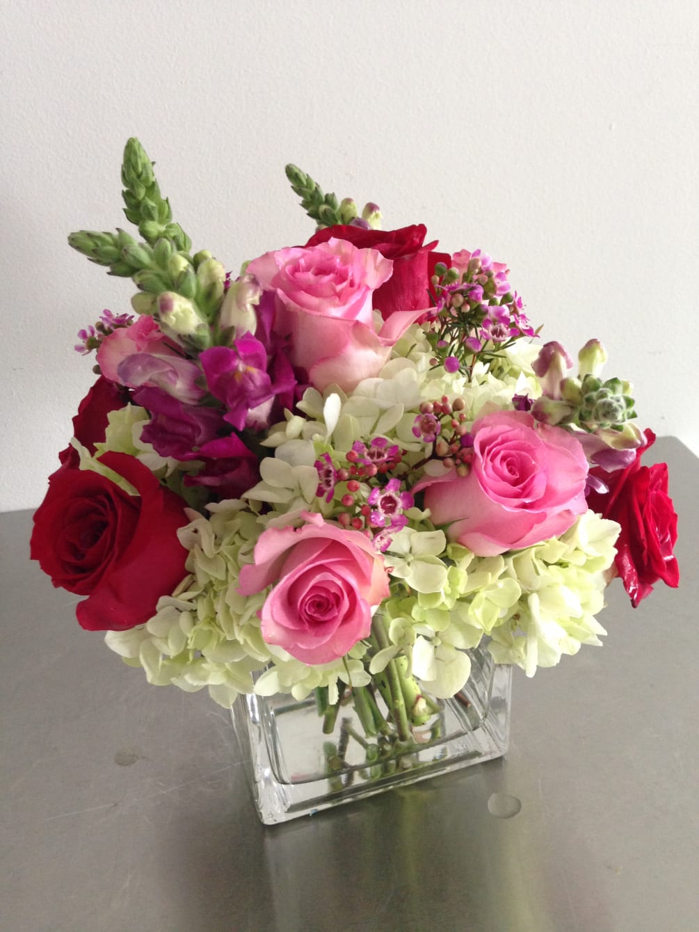 To celebrate love, a collection of roses, hydrengeas and snapdragons in a