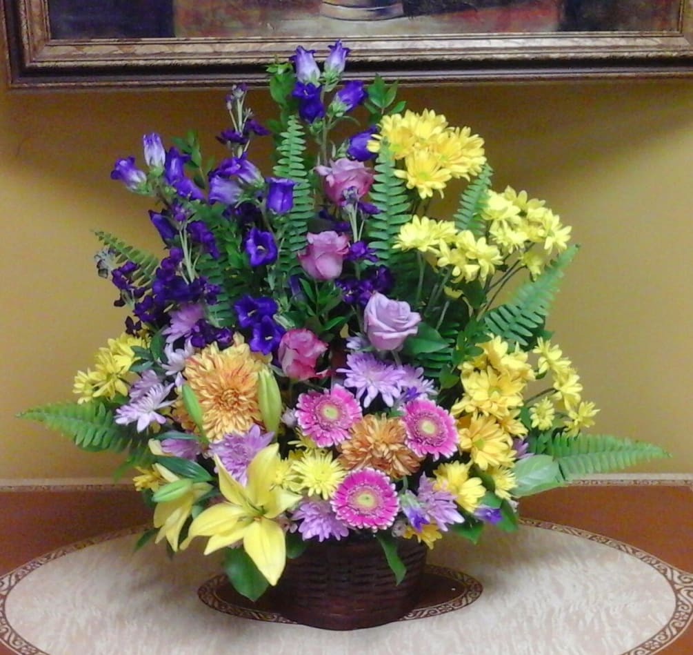 Bright and beautiful basket with bright yellows, deep purples accented with lavender