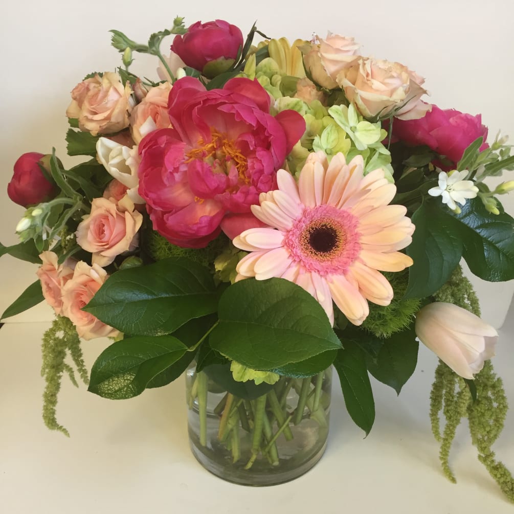 Large cylinder style vase in pinks and greens with a seasonal selection