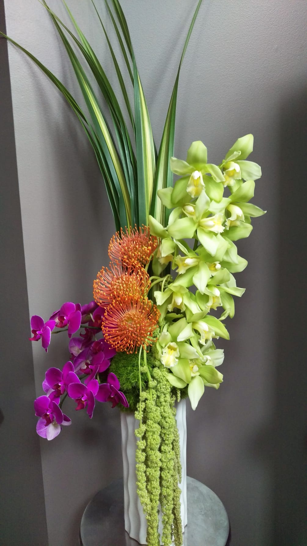 Pin cushion protea, trick, hanging amaranthus, cymbidium &amp; phal orchids in a