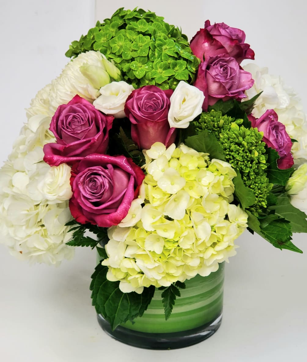 Gorgeous  hydrangeas. Roses, lisianthus and football mums in a cylinder vase