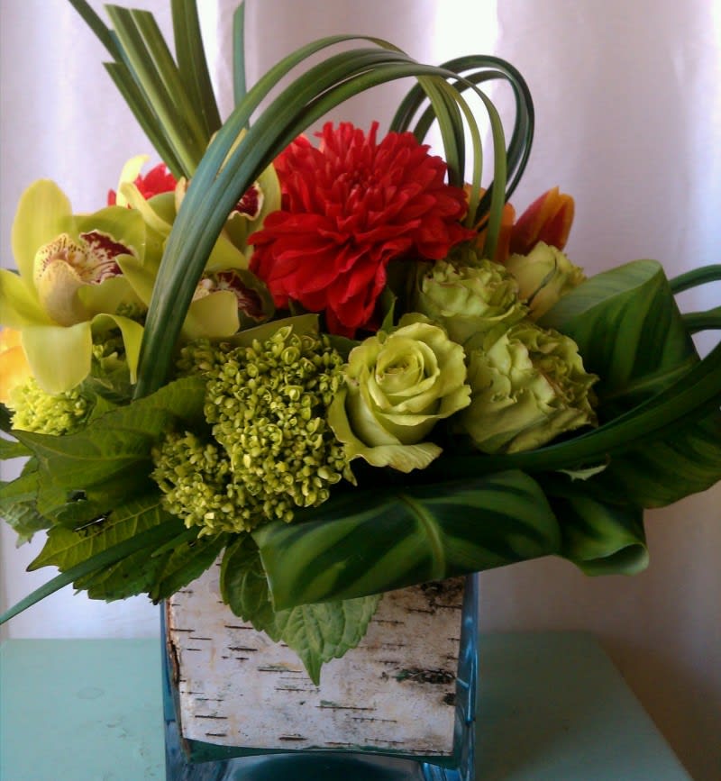 Green Roses, Hydrangea and Orchids en-capsuled in a unique variety of leaves