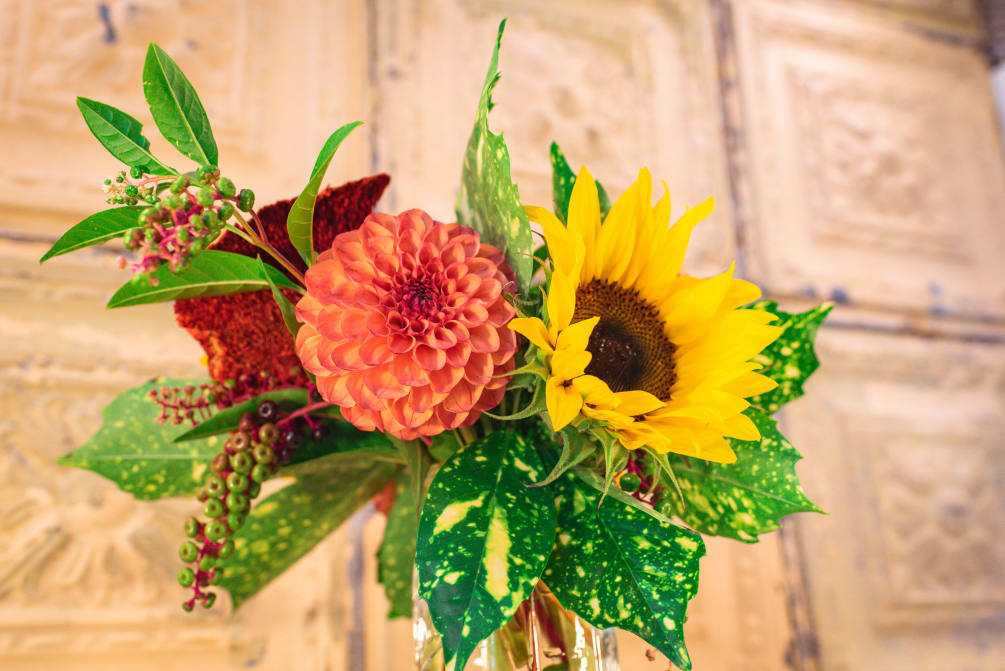 We love this red, peach, and yellow color palette! This arrangement consists