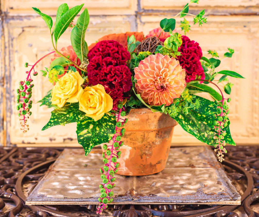 A whimsical arrangement of Dhalias, cockscomb, spray roses, chokeberries, and vine balls.