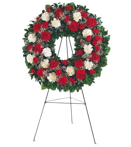 This vivid red and white wreath honors a loved one by sharing
