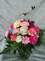 A beautiful arrangement of every color carnation available.  Adorned with a