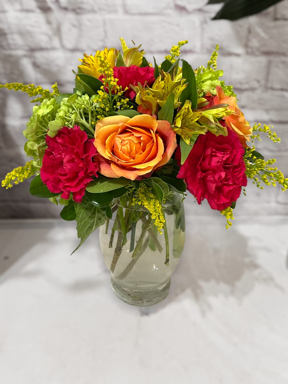 A beautiful and vibrant bouquet of flowers arranged in a glass vase.