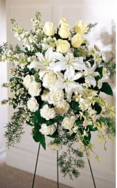 A MIXTURE OF WHITE FLOWERS ON AN EASEL 