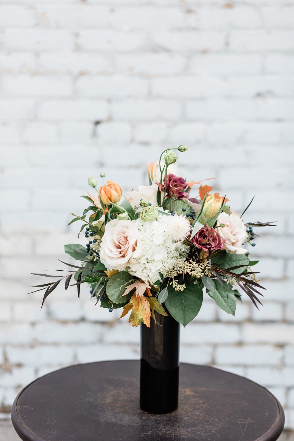 Stunning mix of fall blooms with touches of purples, oranges, and other