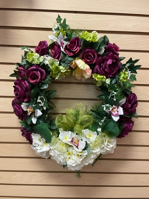 Grapevine wreath with silk green, mauve, and white flowers