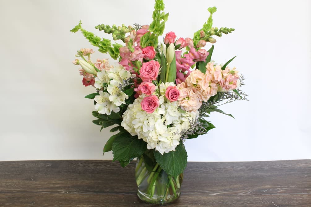 Express hope with this lush flower arrangement in a mix of pinks