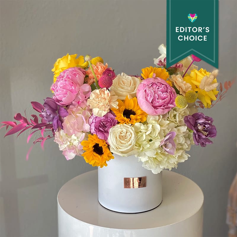 Summer mix of peonies, sunflowers, hydrangea, orchids, tulips, roses, royal carnation, and