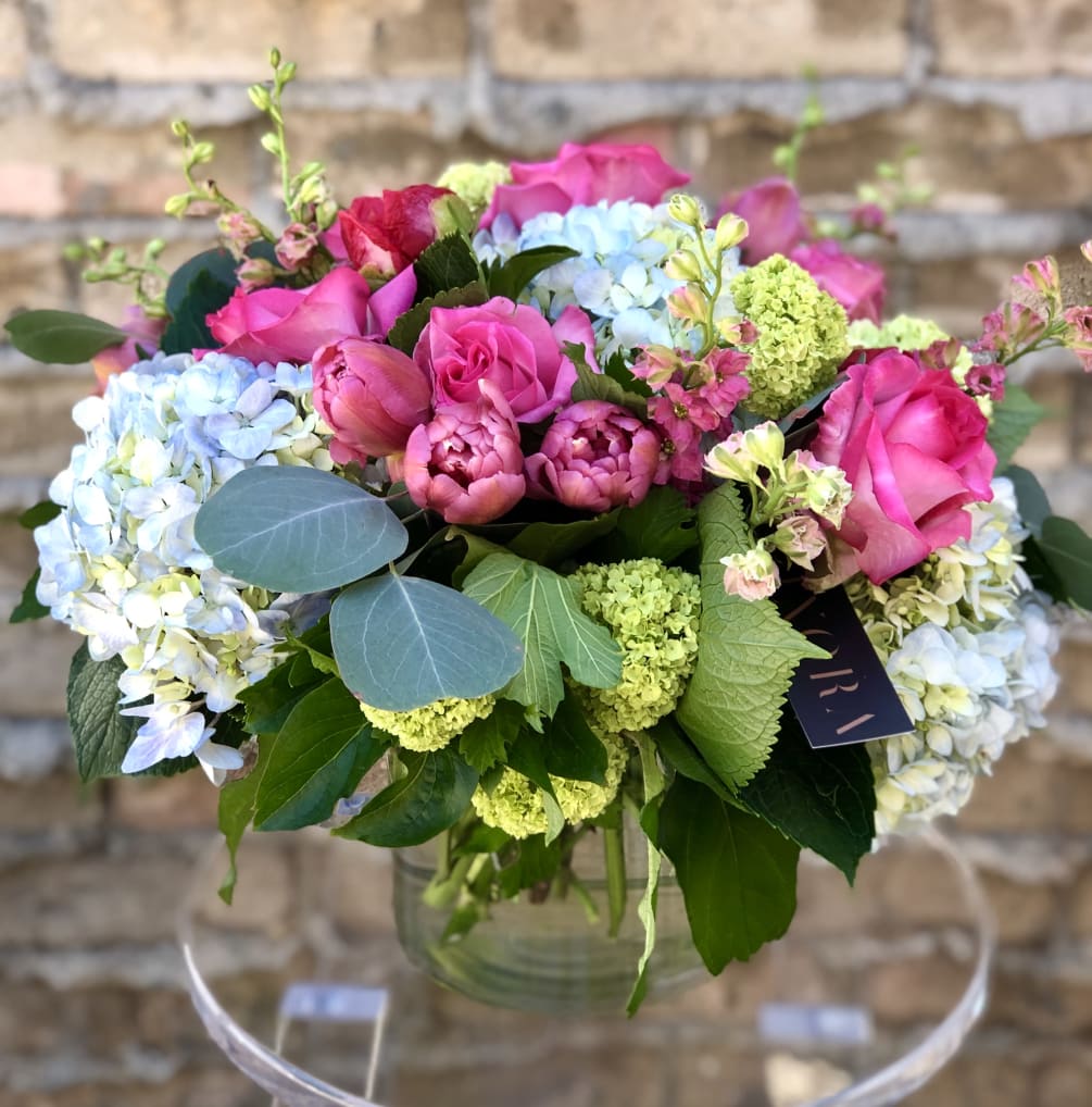 DELUXE VERSION SHOWN* Designed with hot pink ross, pink tulips, green viburnum