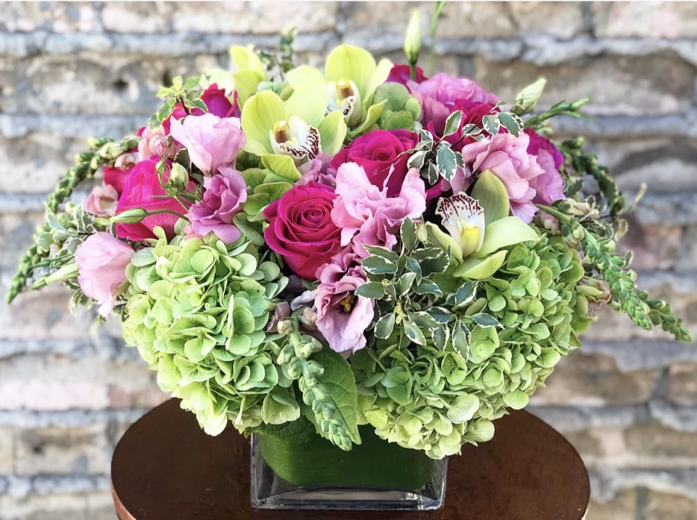 DELUXE VERSION SHOWN*
Designed with Hot pink roses, green hydrangea, green cymbidium orchids