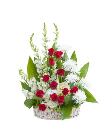 A basket filled with a variety of red and white flowers.
Approximate Size: