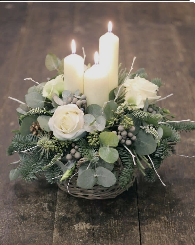 Our white roses ir a wintertime favorite. This centerpiece arrives in a