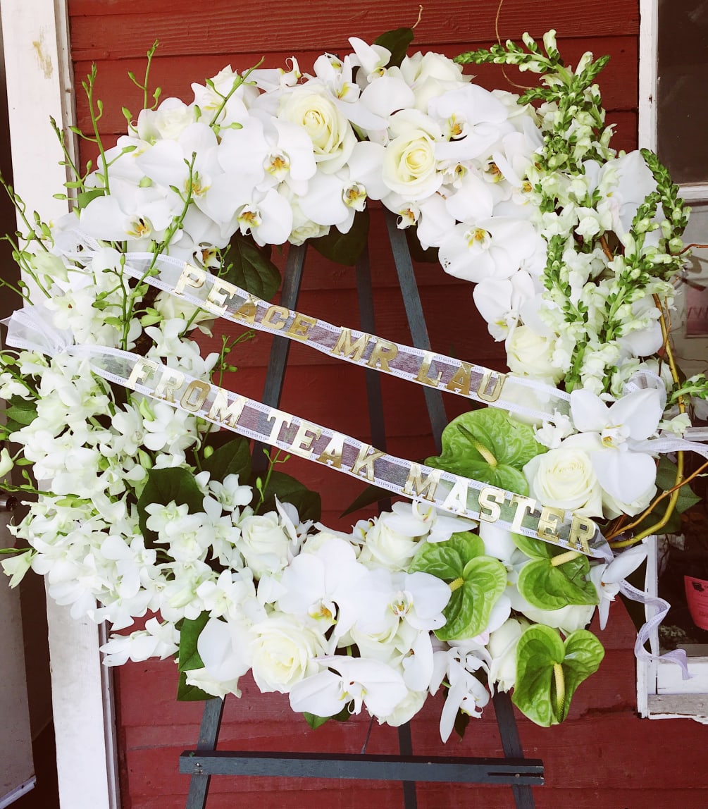 *DELUXE VERSION SHOWN *Classic white sympathy wreath made with roses, snapdragons, mixed